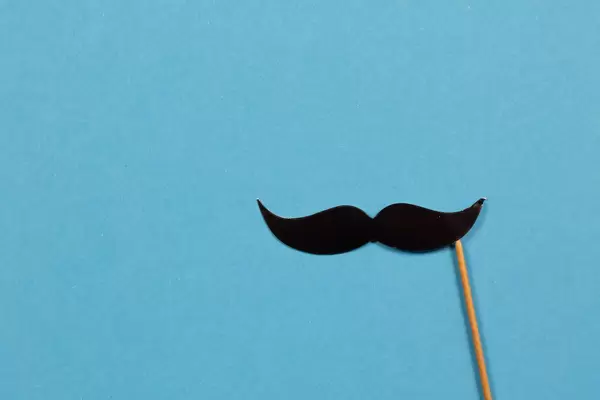 Paper mustache on blue background