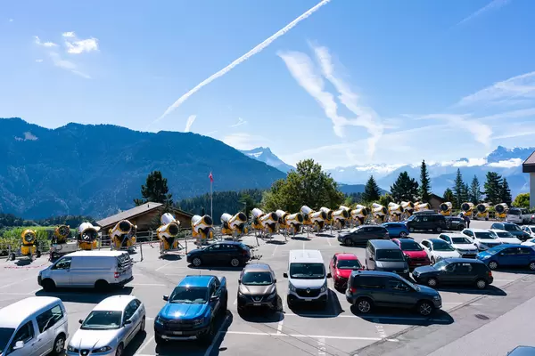 Parking lot in Swiss mountains full of snowguns during low season