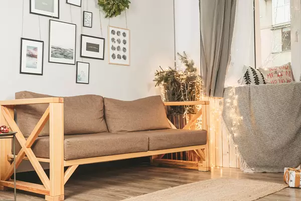 Part of a decorated christmas living room with sofa and window