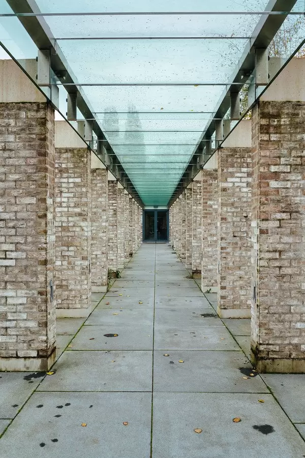 Passage with glass roof and Brik columns at cemetery complex De Nieuwe Noorder in Amsterdam