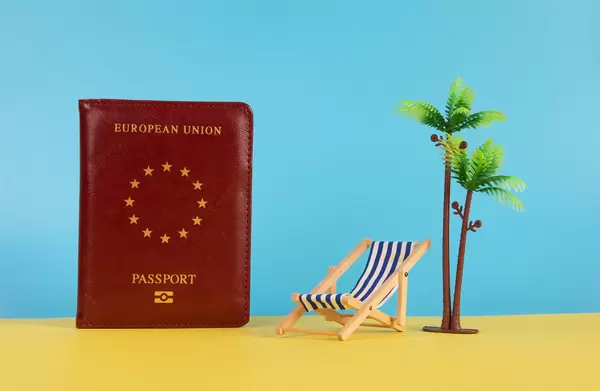 Passport, deck chair, and palm tree
