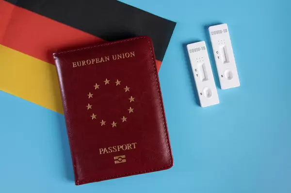 Passport with flag of Germnay and rapid antigen tests