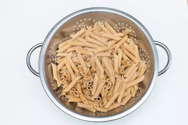 Pasta in a Colander on a White Background   Flip 2019