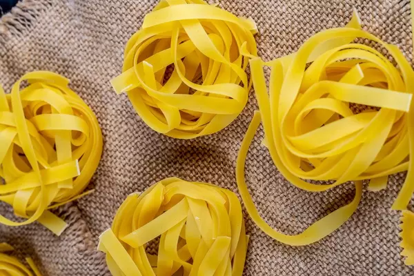 Pasta in the shape of a nest on the background of burlap (Flip 2019)