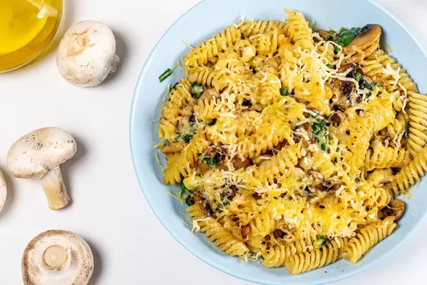 Pasta with mushrooms, cheese and spinach. View from above