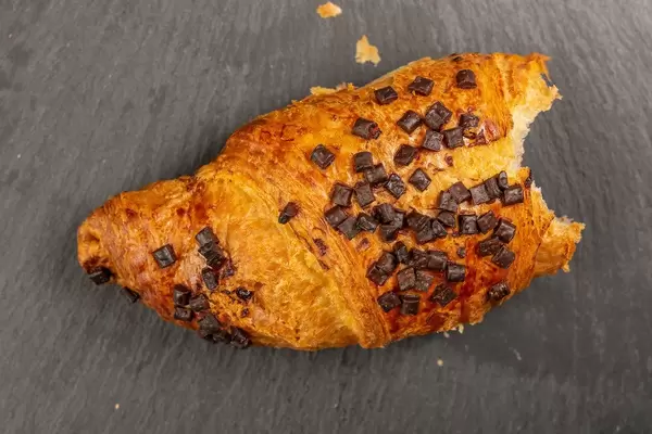 Pastry Croisant with Chocolate Crumbs on the stone tray (Flip 2019)