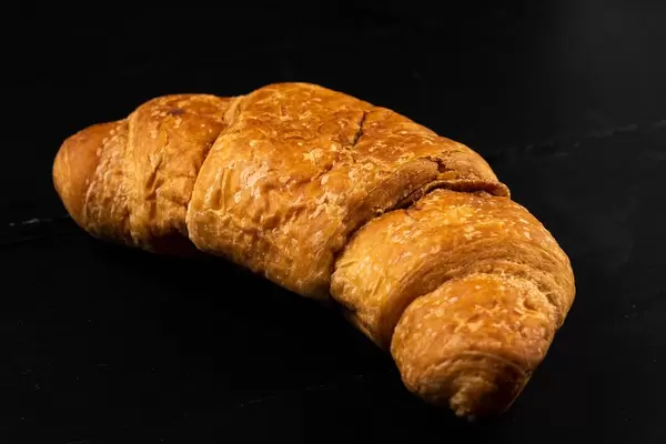Pastry Croissant on the black background