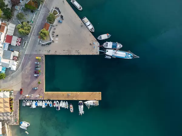 Patitiri Port on Alonnisos: overhead shot of the turquoise waters, boats, pier and parked cars