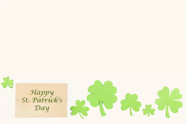 Patrick's day greeting message with clover leaves