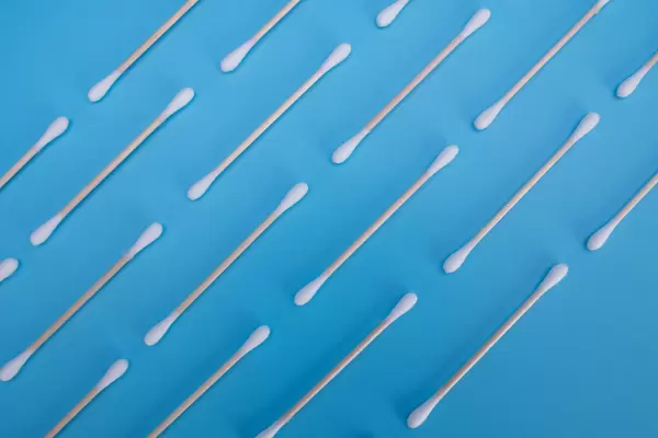 Pattern of zero waste bamboo cotton buds on a blue background