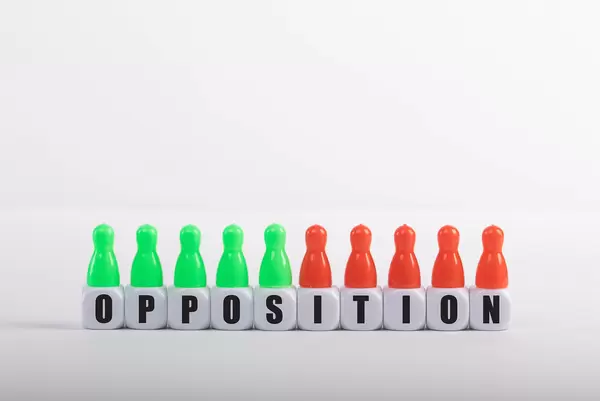 Pawn figurines with cubes and Opposition text