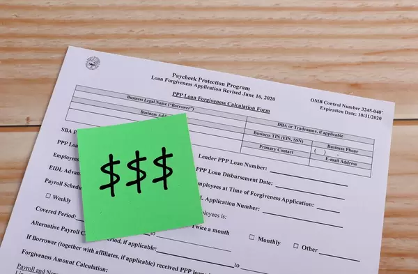 Paycheck Protection Program application and green reminder note