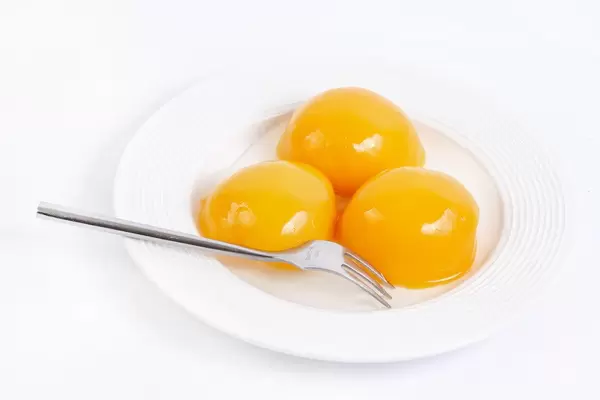 Peach Compote on the plate above white background
