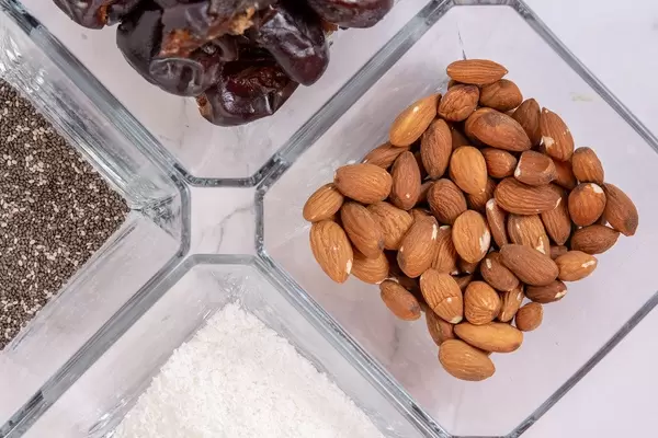 Peanut butter Almonds Coconut Chia Seeds and Dates in the bowls