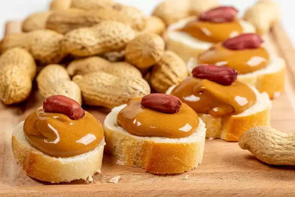 Peanut butter sandwiches on wooden background