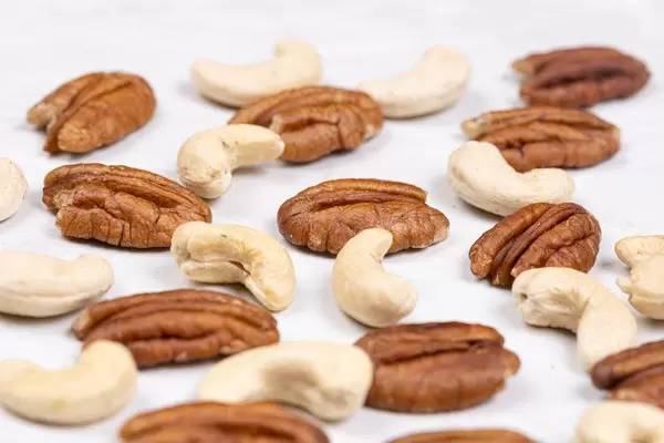 Pecan Nuts and Cashew on the white table