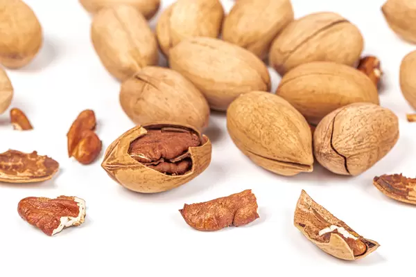 Pecans whole and broken on white