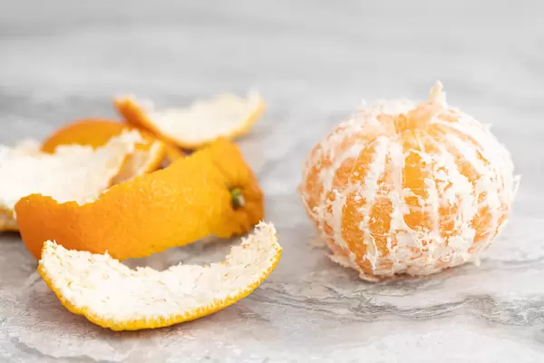 Peeled Orange on the grey table