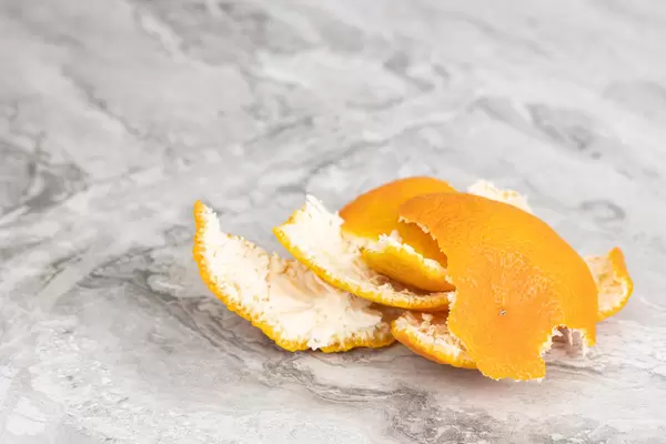 Peeled Orange peel on the table with copy space
