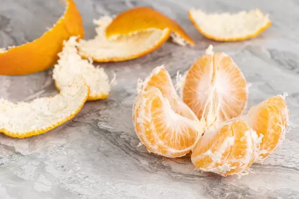 Peeled Orange sliced on the table
