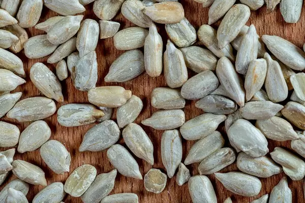 Peeled Sunflower seeds on wooden background. Top view (Flip 2019)