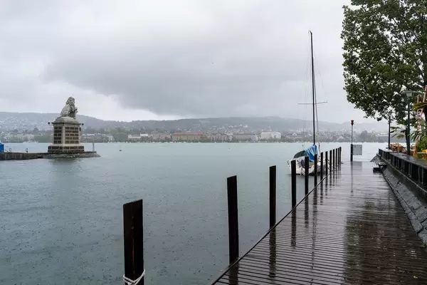 Peer and a boat with lion monument to the left in Zurich, Switzerland