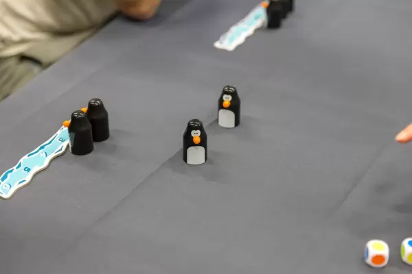 Penguin playing pieces and colorful dice