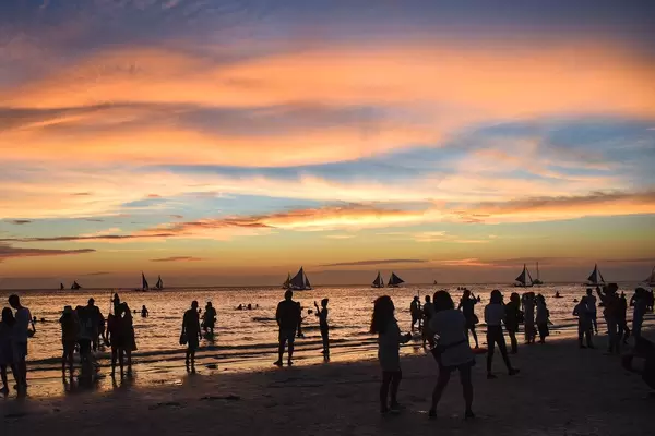 People hanging around the beach during golden hour