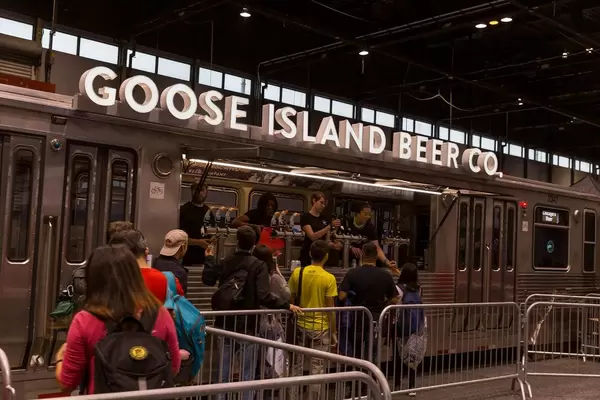 People queuing for Chicago's Goose Island craft beer served at train-like stall