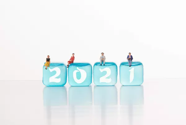 People sitting on blue ice cubes with 2021 text