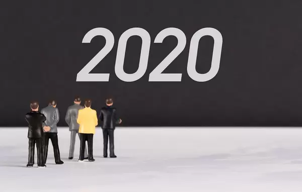 People standing in front of 2020 text
