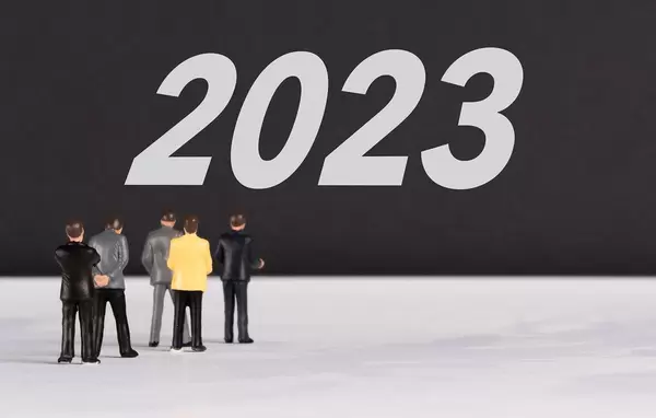 People standing in front of 2023 text