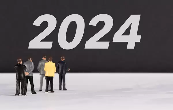 People standing in front of 2024 text