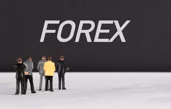 People standing in front of Forex text