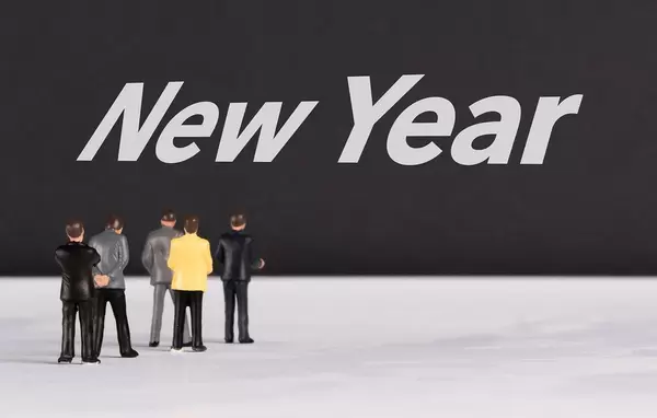 People standing in front of New Year text