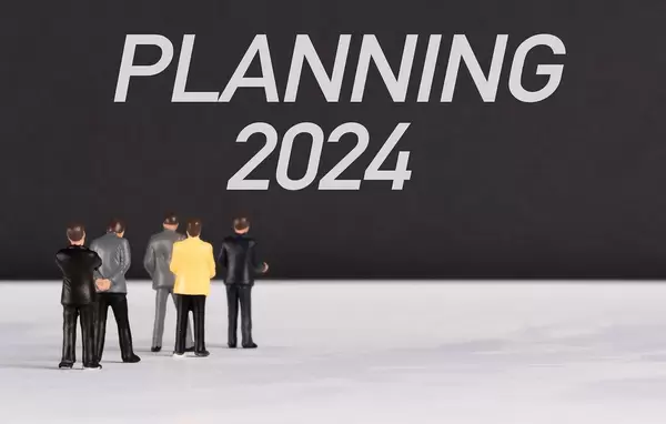 People standing in front of Planning 2024 text