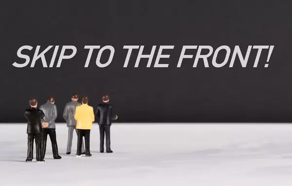 People standing in front of Skip to the front text