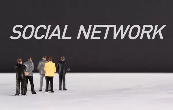 People standing in front of Social Network text