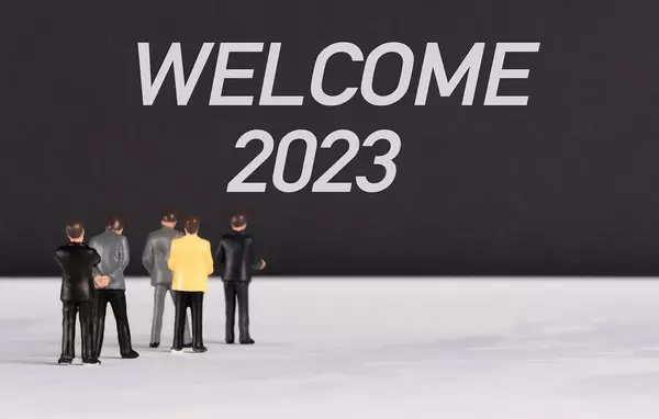 People standing in front of Welcome 2023 text