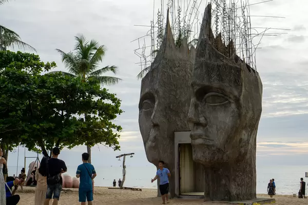People taking Photos at a Sculpture Tunnel at Sunset Sanato Beach Club on Phu Quoc Island in Vietnam