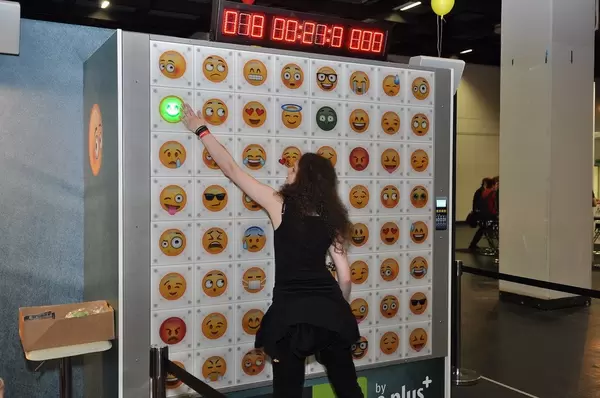 Person doing a reaction test on a wall with emojis and a timer