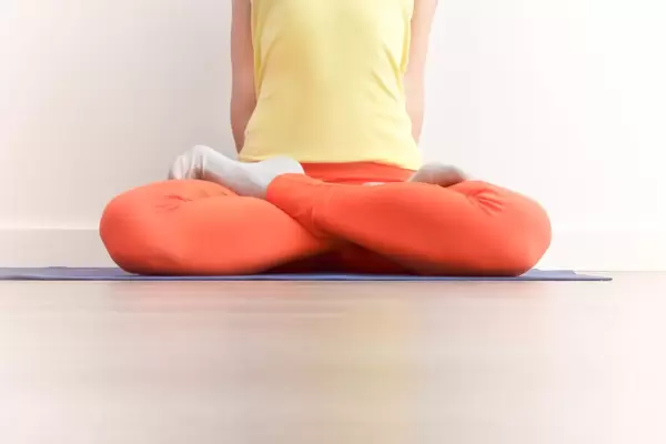 Person performing the Lotus Pose called Padmasana in a Yoga Session