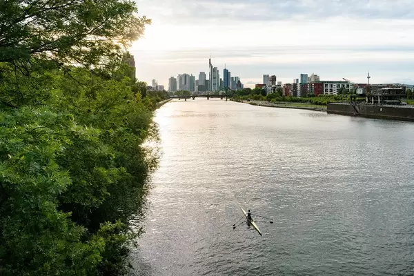 Person rowing in the canoe with beautiful view of Frankfurt skyline