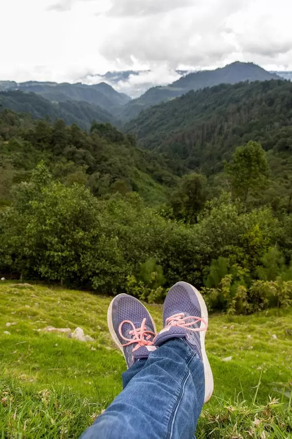 Person sitting at the start of a canyon