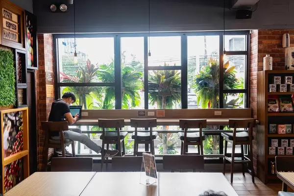 Person sitting on counter table at a local coffee shop in Bacolod