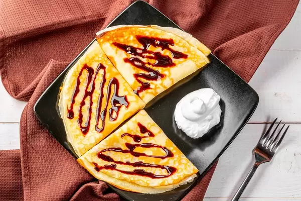 Pfannkuchen mit Schokoladensauce und Sahnecreme