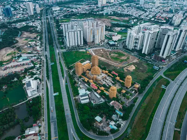 Phap Vien Minh Dang Quang Buddhist Temple next to a Highway and Apartment Buildings in District 2 in Ho Chi Minh City, Vietnam