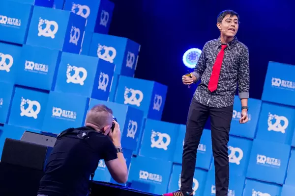 Photographer takes a shot of Tanmay Bakshi on stage
