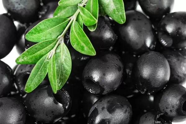 Pickled black pitted olives background