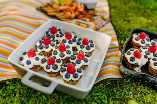 Picnic With  Cream Cupcakes  On The Grass